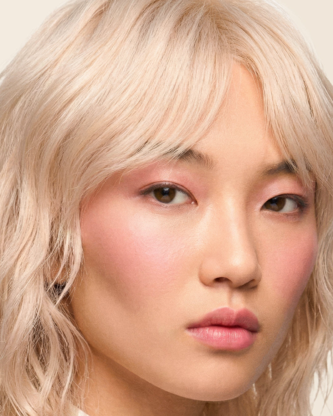 Close portrait of a model with a tousled blonde bob.