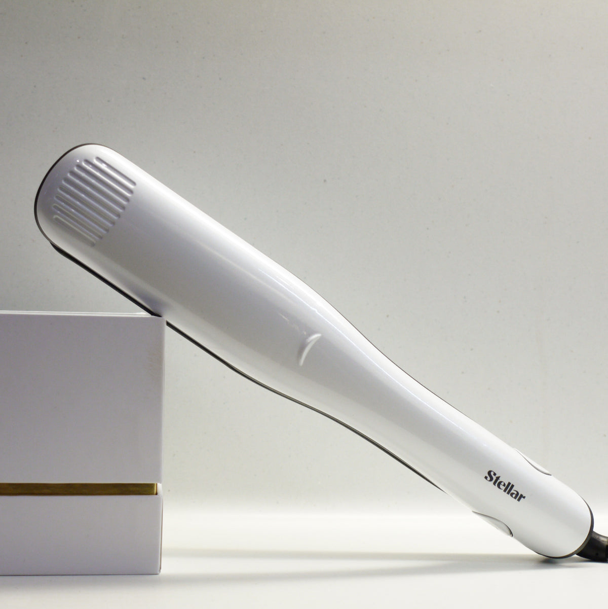 White Stellar Omnia styler beside a pale presentation box